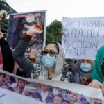 People chant slogans as they carry placards demanding justice during a protest in Karachi