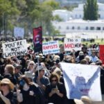 Black-clad women rally in Australia to demand gender violence justice