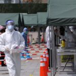 China reports more Covid-19 cases while some cities kick off new tests