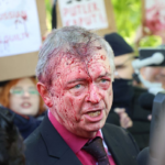 Russian ambassador doused in red by anti-war protesters in Poland