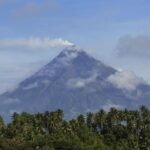 Rescuers climb Philippine volcano to reach plane crash site