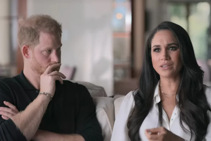 Prince Harry sits with wife Meghan Markle during an interview for their Netflix series